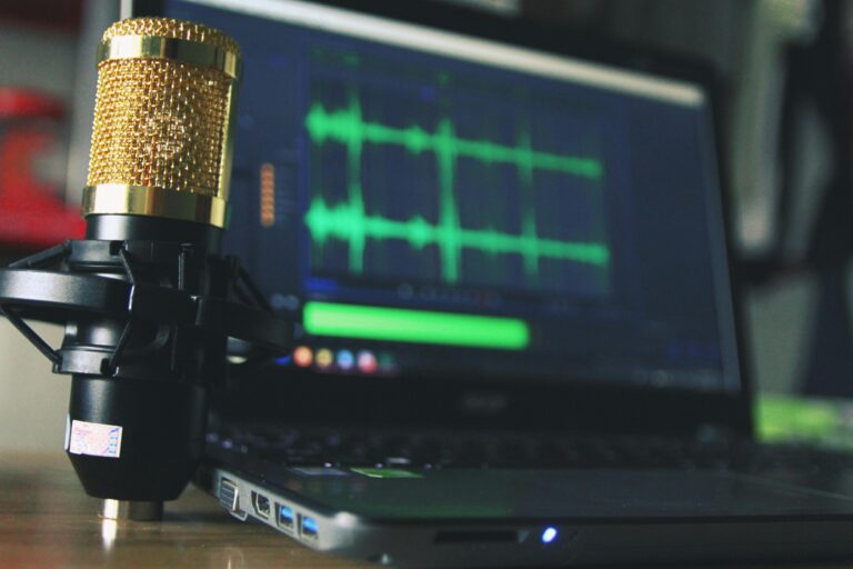 a Laptop and a microphone, ready to record a podcast episode.